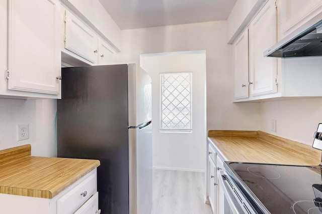 kitchen with stainless steel refrigerator, light hardwood / wood-style flooring, ventilation hood, range with electric stovetop, and white cabinets