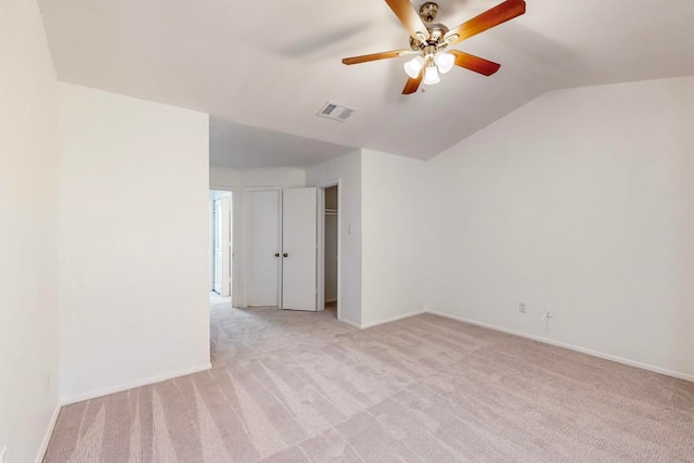 carpeted spare room featuring ceiling fan and lofted ceiling