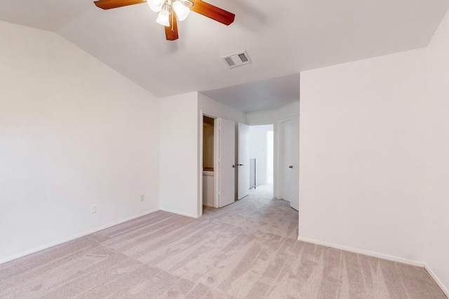 carpeted spare room with ceiling fan and lofted ceiling