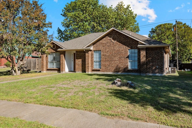 single story home featuring a front yard and central AC unit