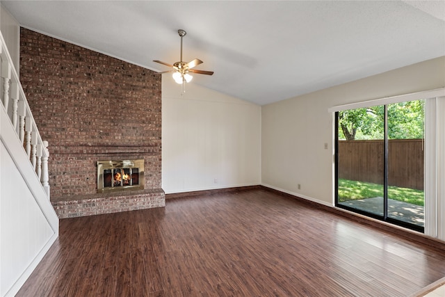 unfurnished living room with dark hardwood / wood-style floors, ceiling fan, a fireplace, and vaulted ceiling