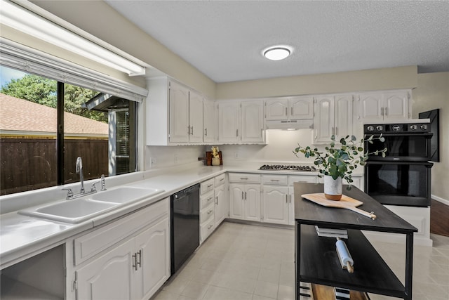 kitchen featuring black appliances, white cabinets, sink, and a textured ceiling