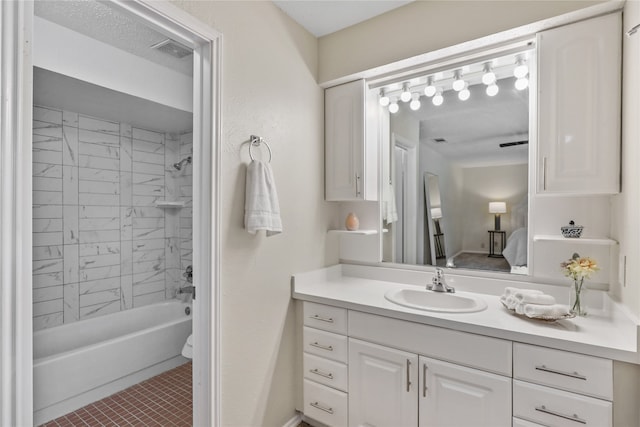 bathroom featuring tile patterned floors, vanity, and tiled shower / bath