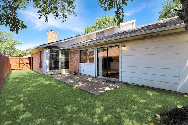 rear view of property with a patio area and a yard