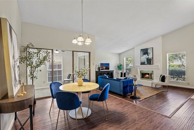 dining room featuring a healthy amount of sunlight, dark hardwood / wood-style flooring, and lofted ceiling