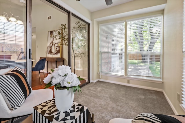 sunroom / solarium with a notable chandelier