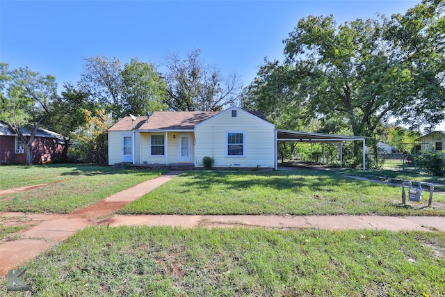 view of front facade with a front yard and a carport