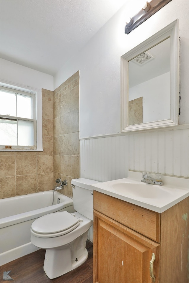 bathroom with hardwood / wood-style floors, vanity, and toilet