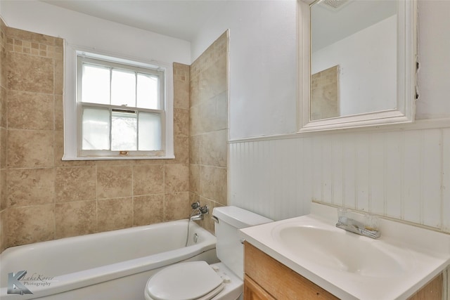 2909 Poplar St, Abilene, TX 79602 - full bathroom featuring toilet, vanity,  shower combination, and a wainscoted wall