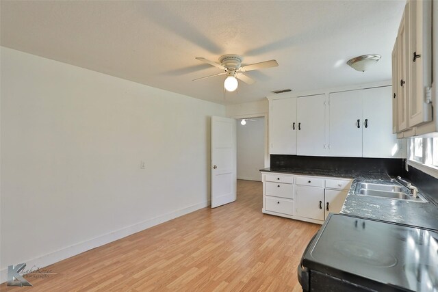 2909 Poplar St, Abilene, TX 79602 - kitchen with a sink, a ceiling fan, light wood-style floors, black / electric stove, and white cabinets