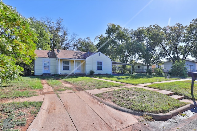 view of front facade featuring a carport and a front yard