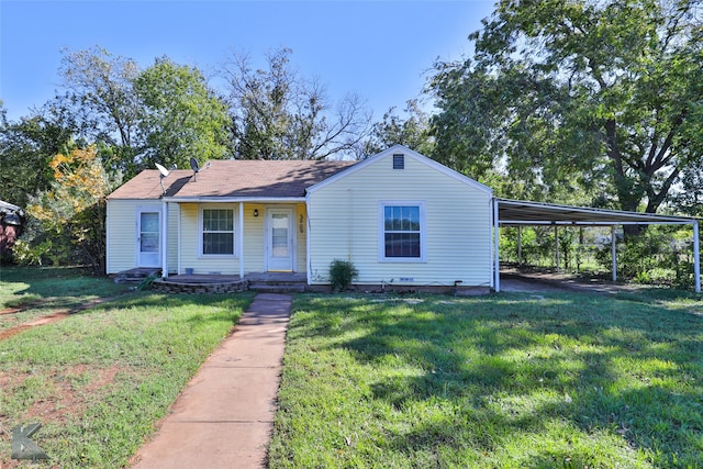 view of front facade with a front yard and a carport