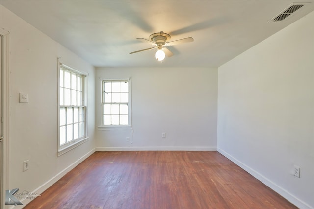 empty room featuring dark hardwood / wood-style floors and ceiling fan