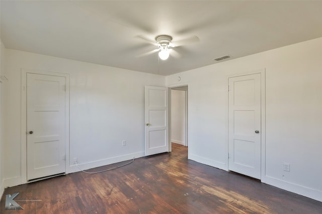 unfurnished bedroom featuring ceiling fan and dark wood-type flooring