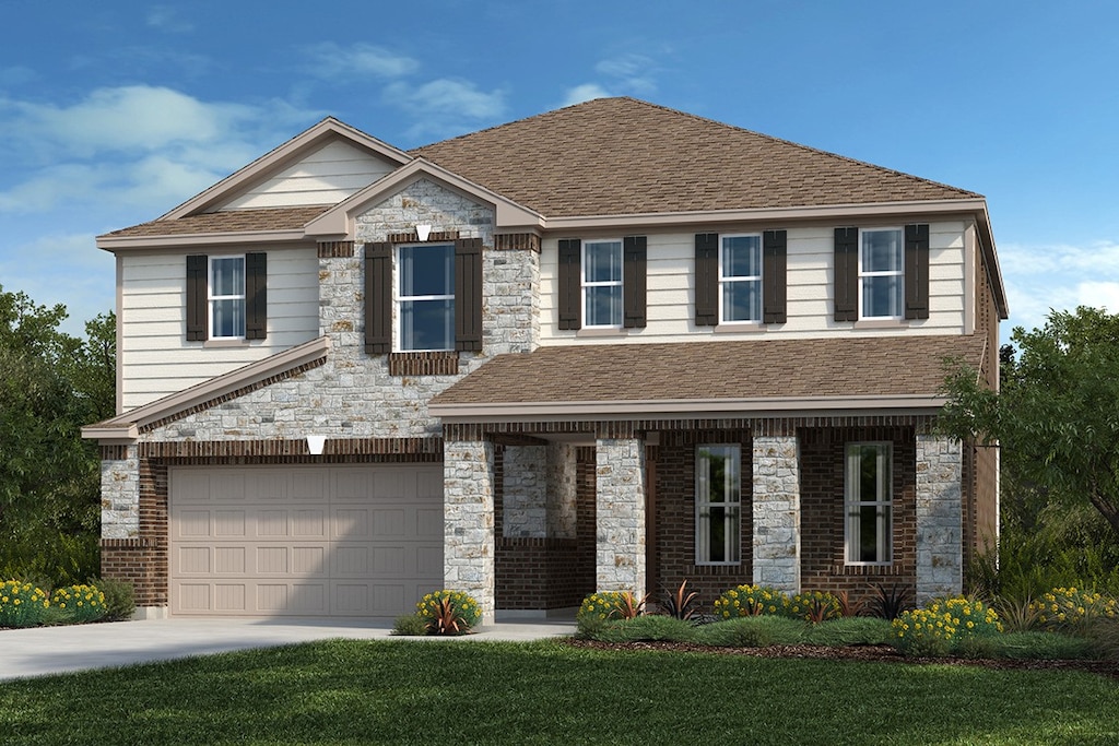 view of front of property featuring a garage and a front lawn