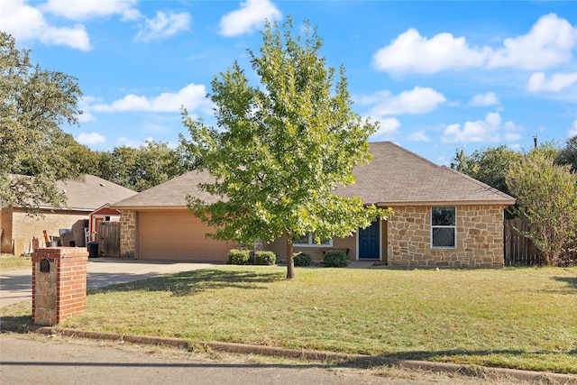 view of front of home featuring a front yard and a garage