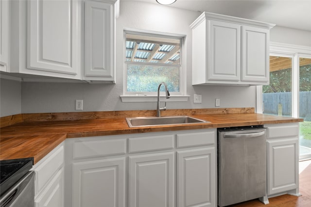 kitchen featuring wood counters, white cabinetry, sink, and appliances with stainless steel finishes