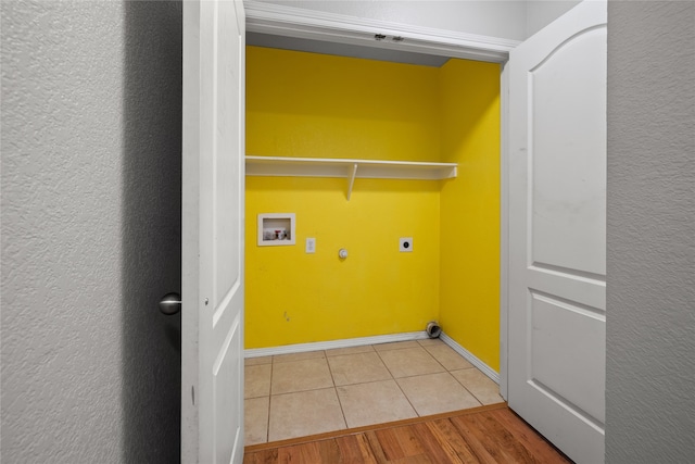 washroom featuring washer hookup, light wood-type flooring, and electric dryer hookup