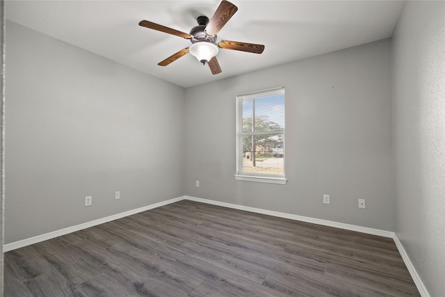 unfurnished room with ceiling fan and dark wood-type flooring