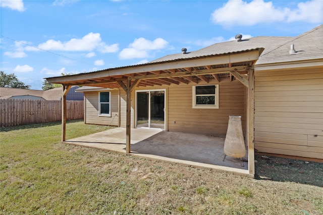 rear view of property with a yard and a patio