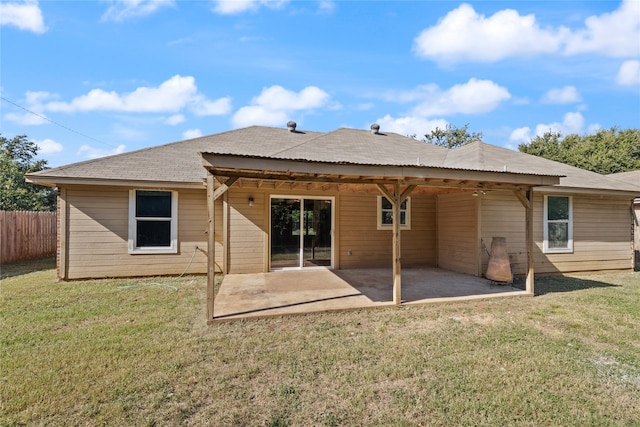 rear view of house with a yard and a patio