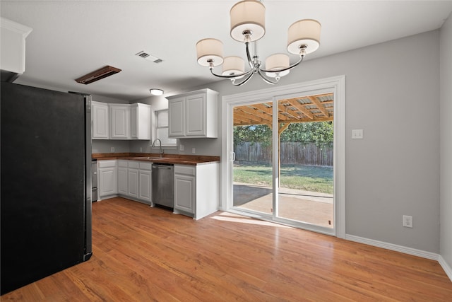 kitchen featuring white cabinetry, sink, light wood-type flooring, and appliances with stainless steel finishes