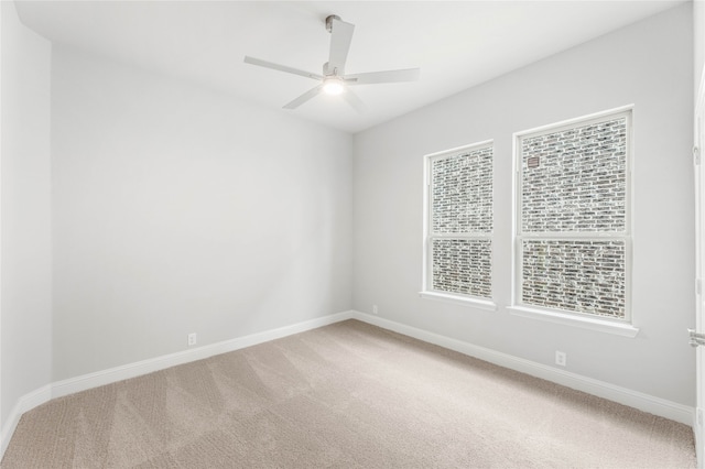 unfurnished room with ceiling fan and carpet floors