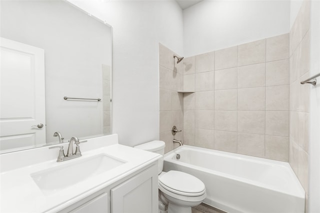 full bathroom featuring vanity, toilet, and tiled shower / bath