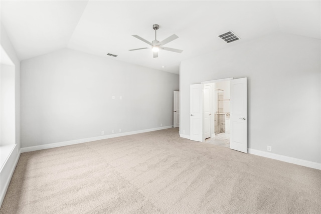 unfurnished bedroom featuring ceiling fan, light carpet, and vaulted ceiling