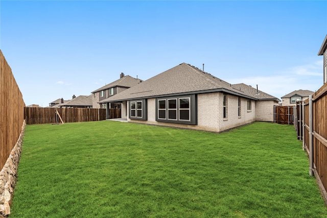 rear view of property featuring a yard