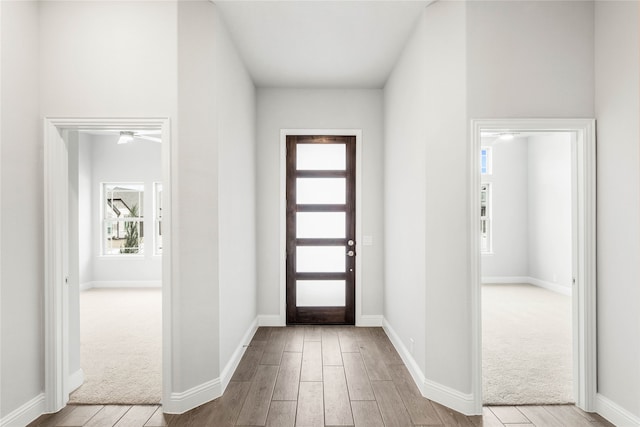 entrance foyer with ceiling fan and light wood-type flooring