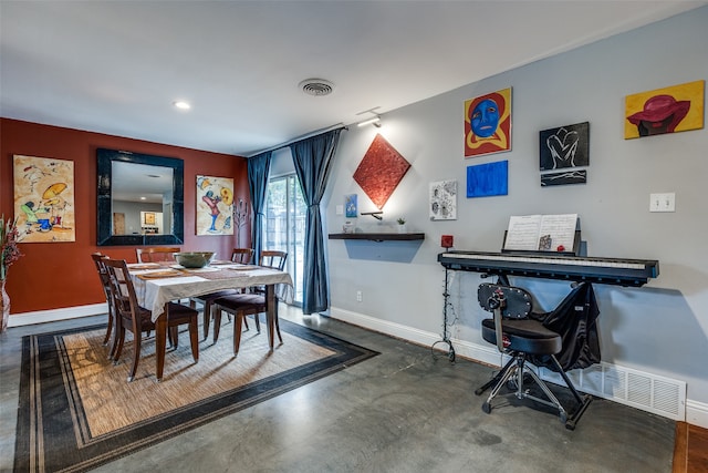 dining space with concrete flooring