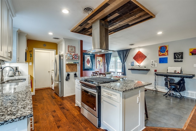 kitchen with sink, white cabinets, dark wood-type flooring, and appliances with stainless steel finishes