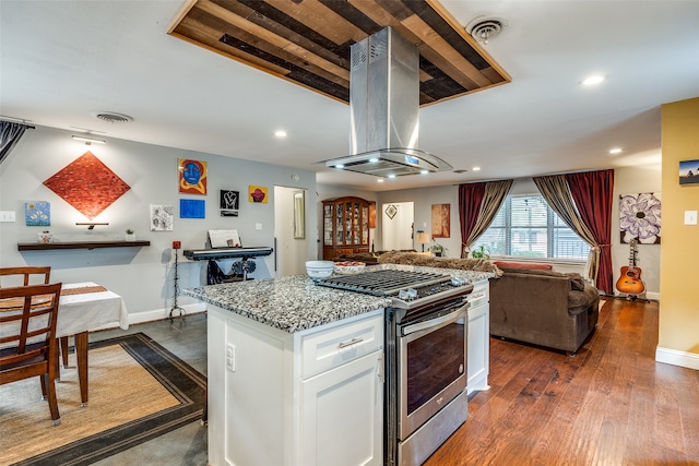 kitchen with a center island, dark hardwood / wood-style floors, white cabinetry, island exhaust hood, and stainless steel range with gas stovetop