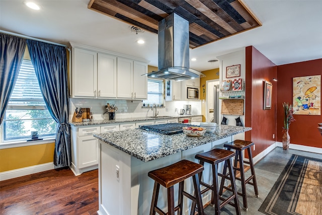 kitchen featuring plenty of natural light, a center island, white cabinetry, and dark wood-type flooring