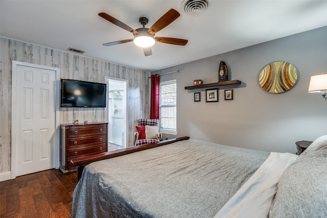 bedroom featuring ceiling fan, dark hardwood / wood-style flooring, and ensuite bathroom