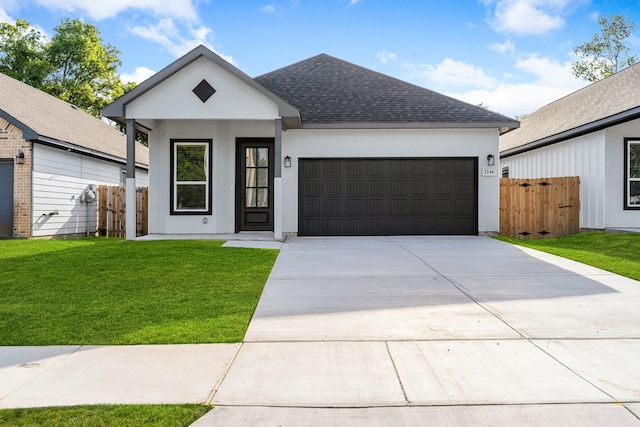 view of front of home featuring a front yard and a garage