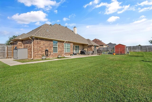 back of property featuring a patio area, a fenced backyard, and a yard