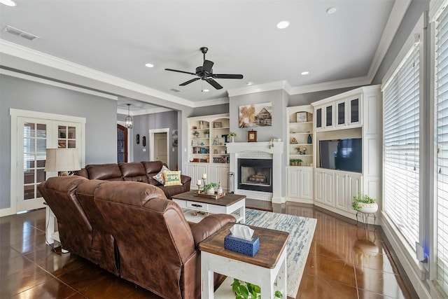 living room featuring recessed lighting, visible vents, a fireplace, and dark tile patterned floors