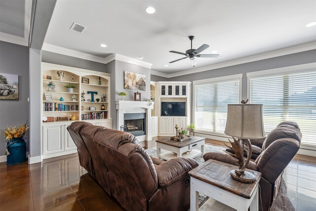 living room featuring visible vents, a ceiling fan, crown molding, a fireplace, and recessed lighting