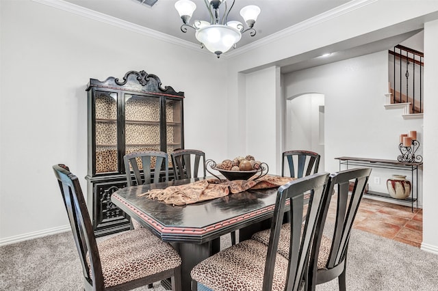 carpeted dining room featuring an inviting chandelier and crown molding