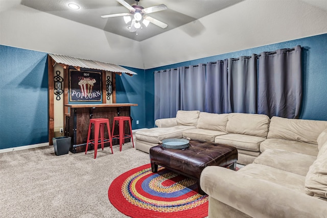 carpeted living room featuring ceiling fan and lofted ceiling