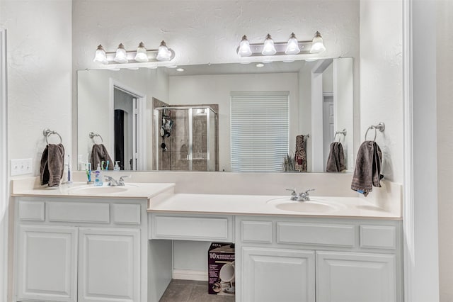 bathroom featuring tile patterned floors, vanity, and an enclosed shower