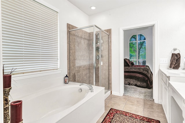 bathroom featuring tile patterned flooring, vanity, and independent shower and bath