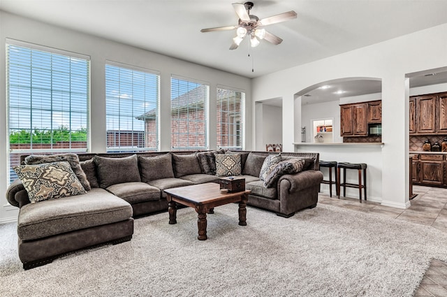 living room featuring ceiling fan and light tile patterned floors