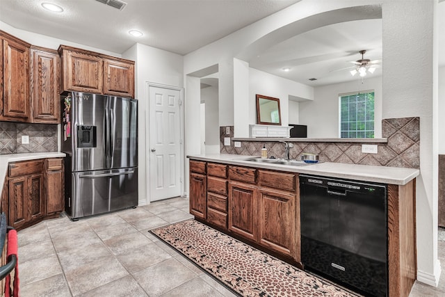 kitchen with ceiling fan, dishwasher, sink, stainless steel refrigerator with ice dispenser, and decorative backsplash