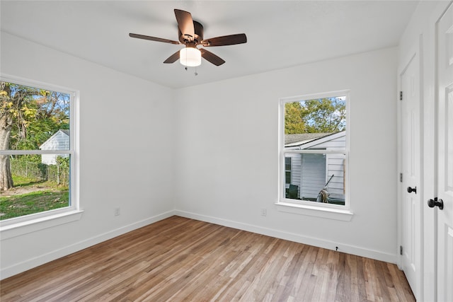 unfurnished bedroom with ceiling fan, light hardwood / wood-style flooring, and multiple windows