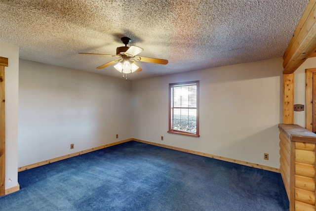 carpeted empty room featuring a textured ceiling and ceiling fan