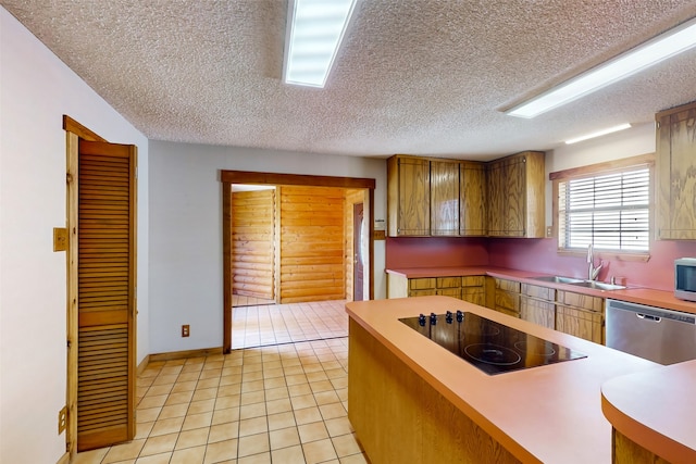 kitchen featuring a textured ceiling, light tile patterned floors, sink, and appliances with stainless steel finishes