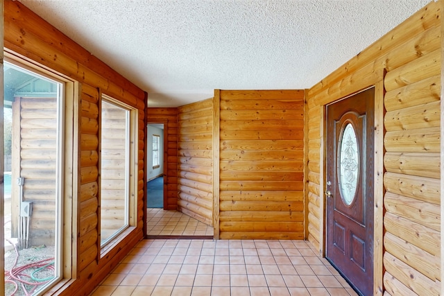 entryway featuring a textured ceiling and log walls